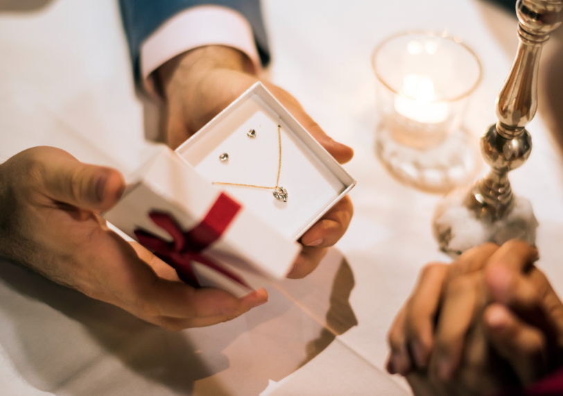 Person opening jewelry gift box