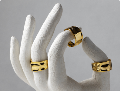 Gold rings on white hand display