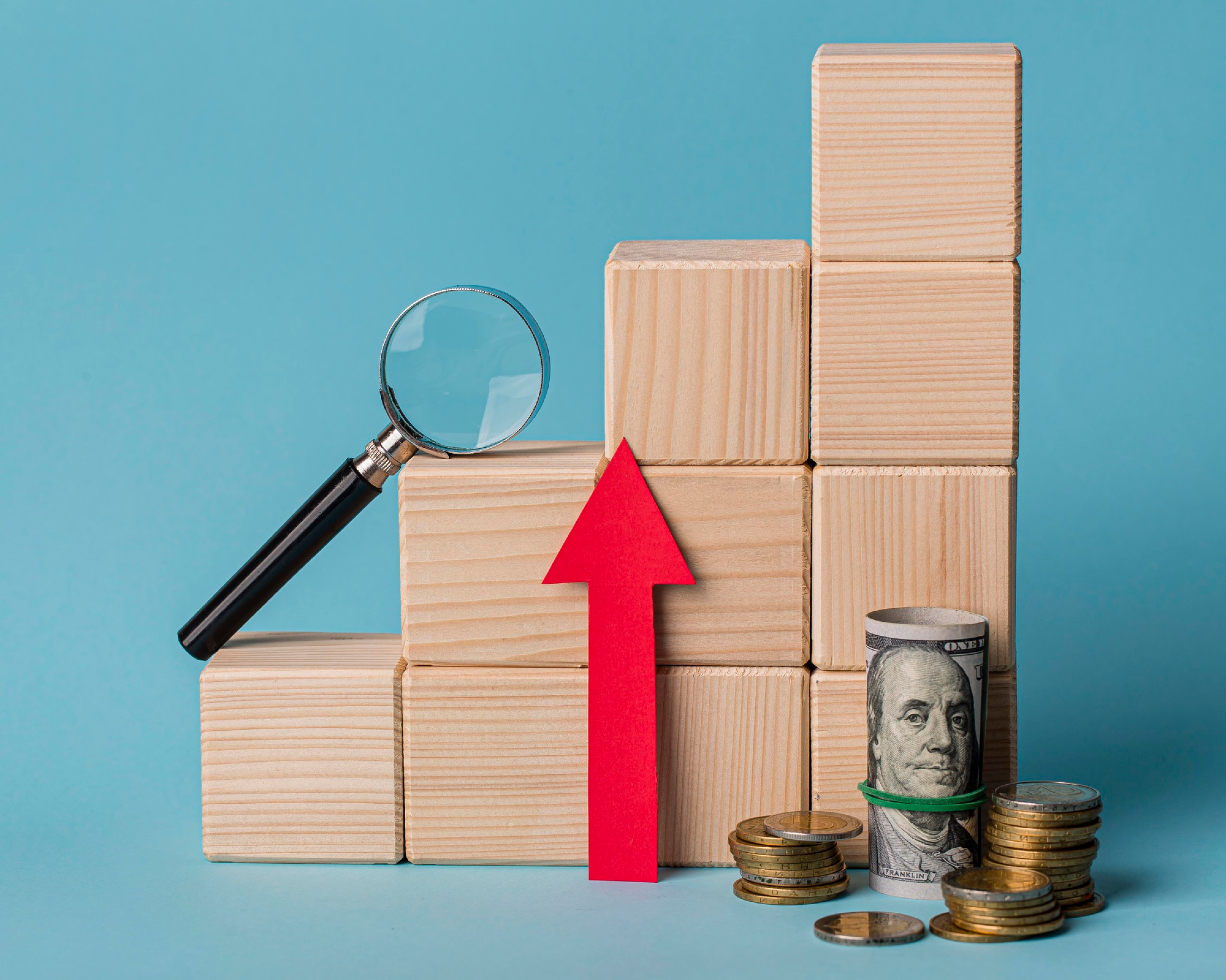 Stacked boxes with magnifying glass and money